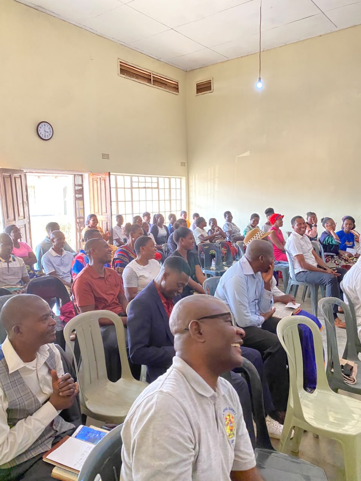Members of the congregation seated together in the church hall.