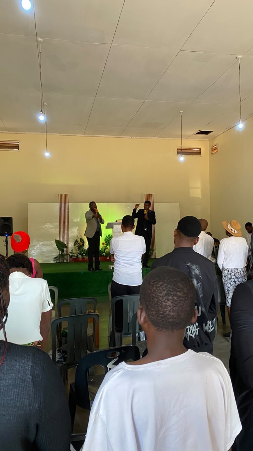 A view from the congregation towards leaders on the church platform.