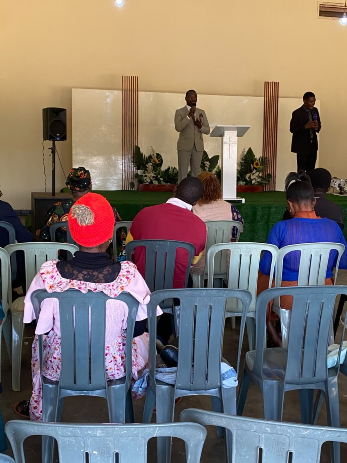 Members seated and listening to speakers at the front of the church.