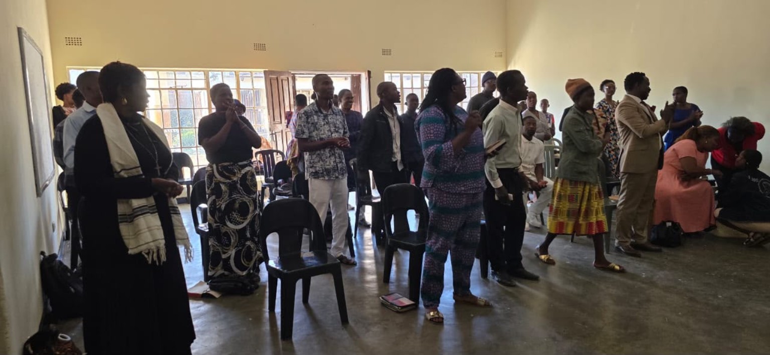 Congregation members gathered for worship in the church hall.
